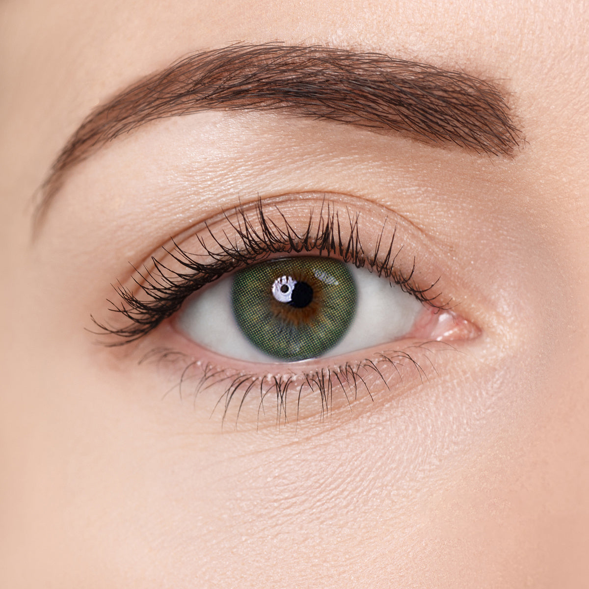 Close-up of an eye wearing Aura Lens in Aura Green color – vibrant green contact lens with a natural, bright finish.