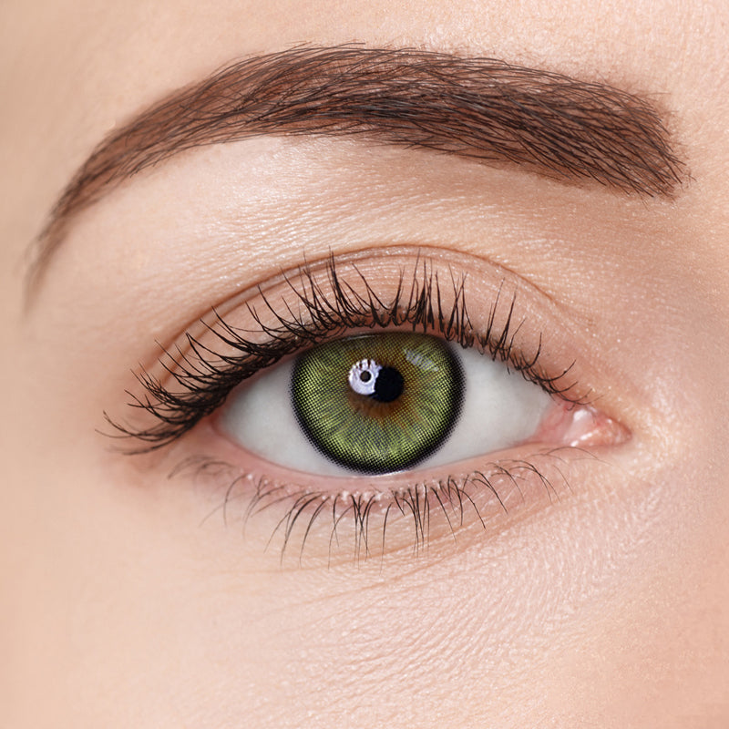 Close-up image of Aura Lens contact lens in Crystal Green shade, showing natural green tones designed to enhance eye color with a vibrant yet subtle look.