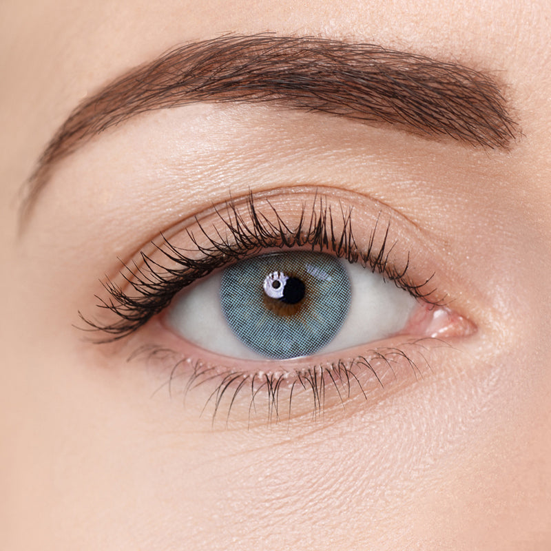 Close-up image of Aura Lens contact lens in Icy Blue shade, showing natural blue tones designed to enhance eye color with a vibrant yet subtle look.