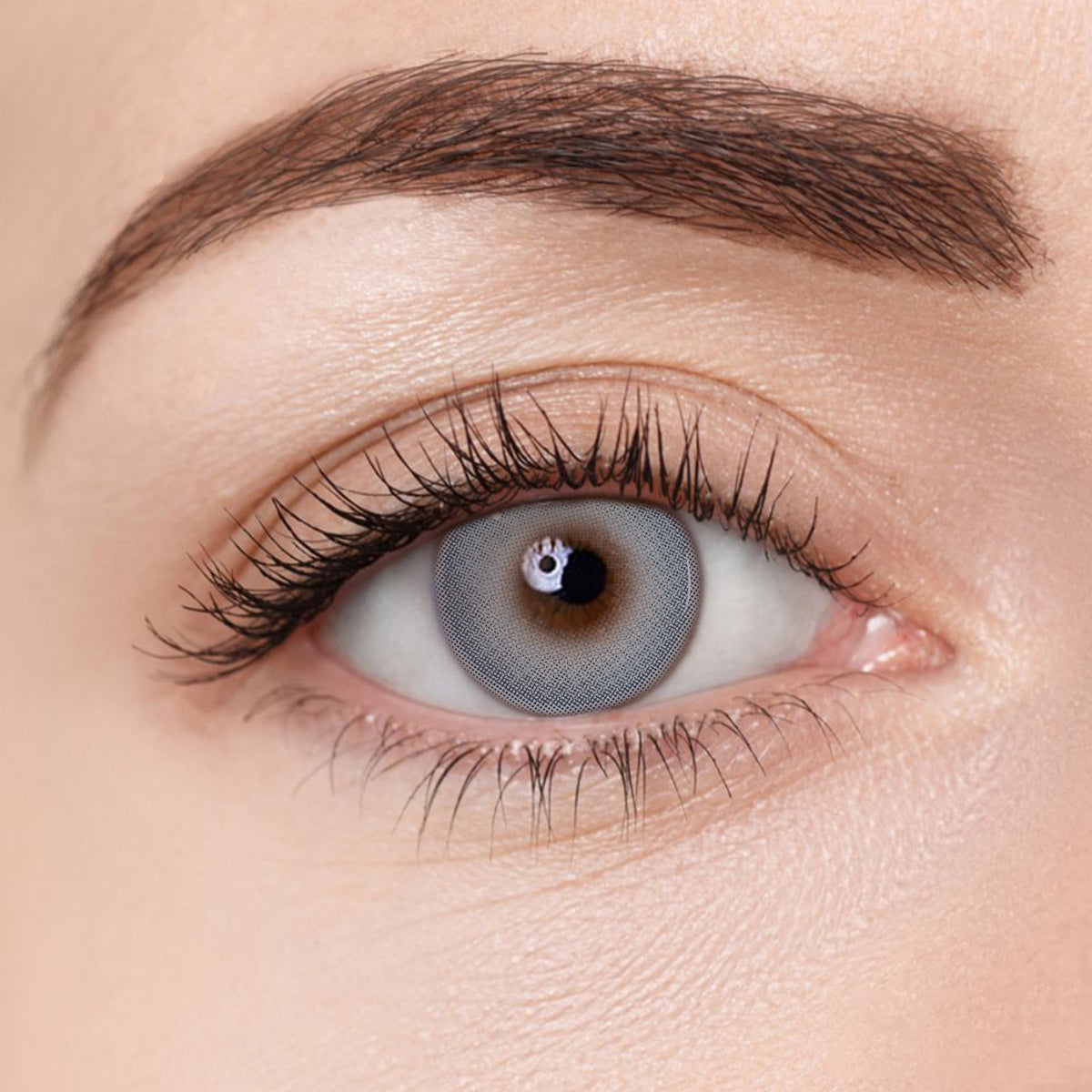 Moonstone Blue colored contact lens by Aura Lens, enhancing eye color with a cool, vibrant blue shade.