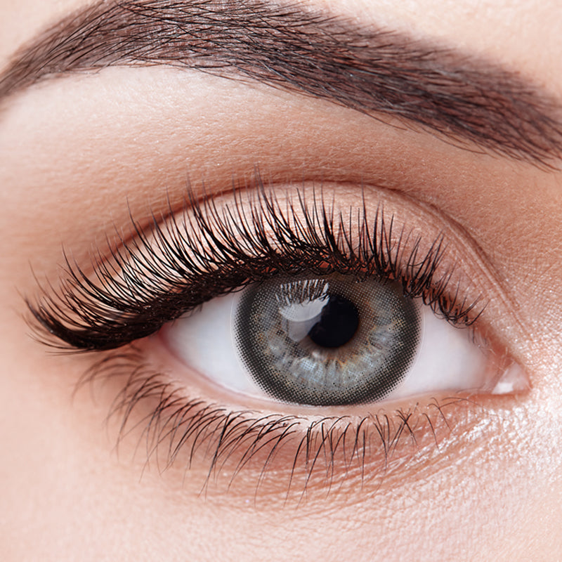 Aura Lens Smoky Grey contact lens worn on dark brown eyes